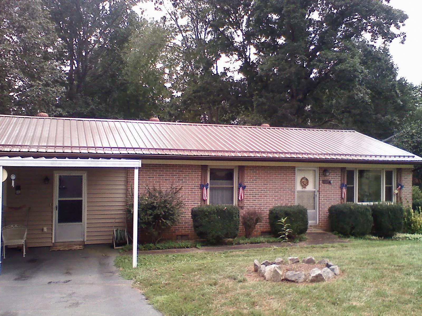 Bronze metal roof and carport on a brick ranch home — Roof Repair work by our crew in Cuddebackville